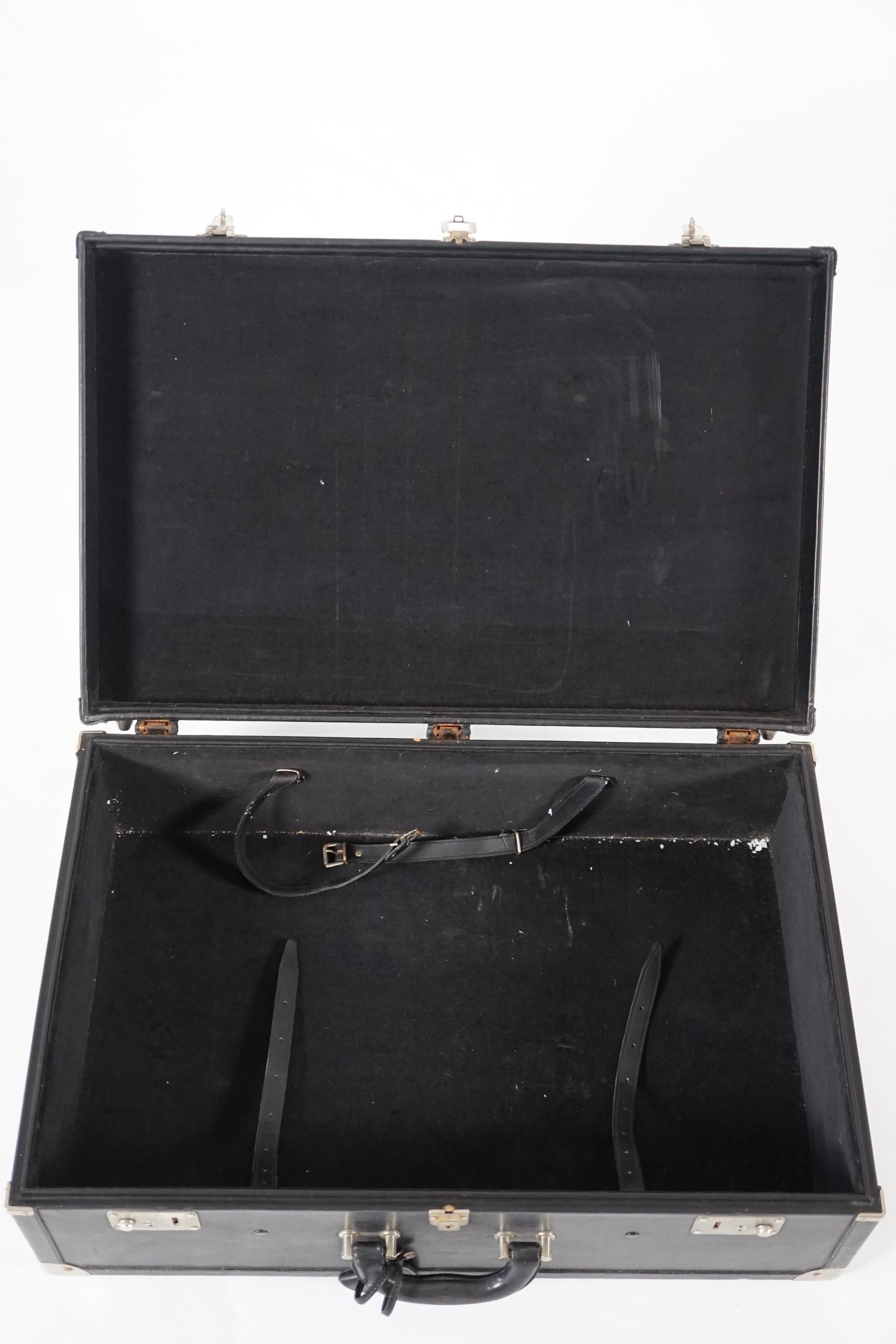 A Nina Cerruti black leather suitcase Length 64.5cm, depth 22cm, width 42cm
